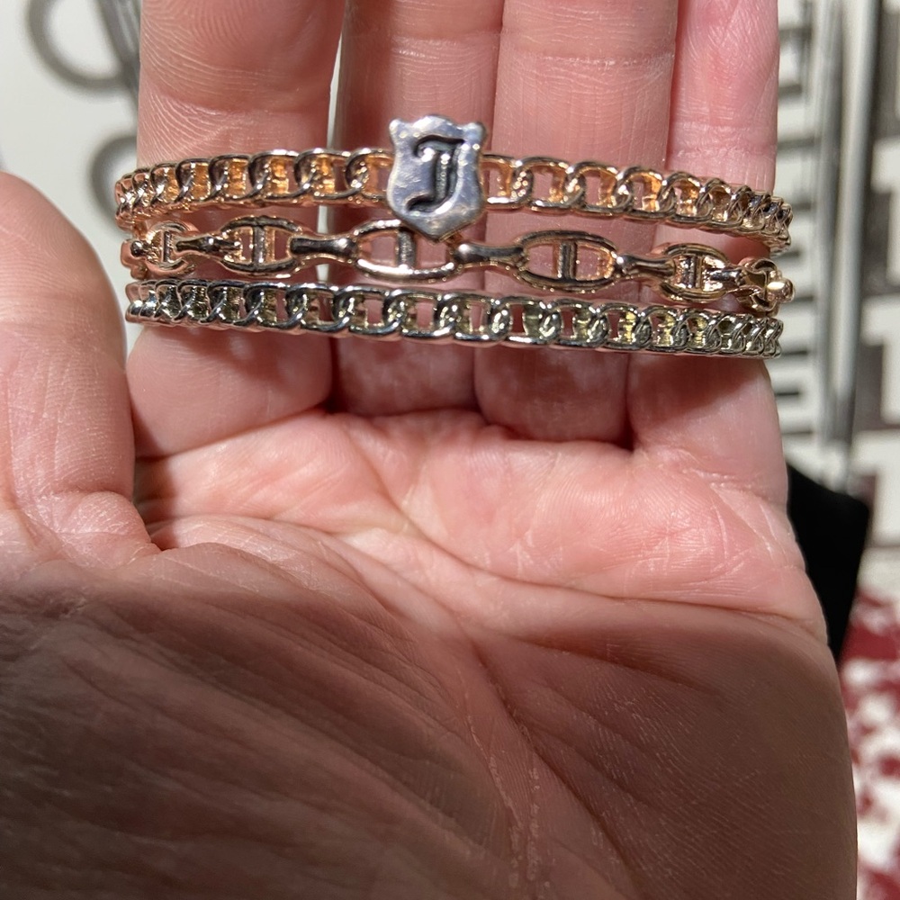 Juicy Couture set of 3 Bangles.  2 Gold Tone 1 Silver Tone.